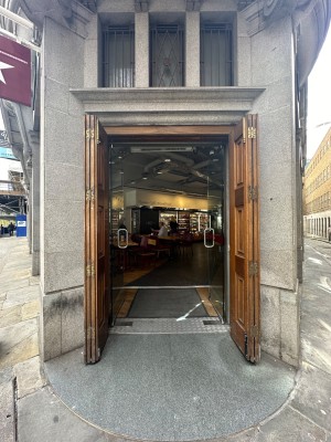 Wooden folding doors, pulled open from centre. Glass doors with silver vertical handle after wooden doors. Push to open.