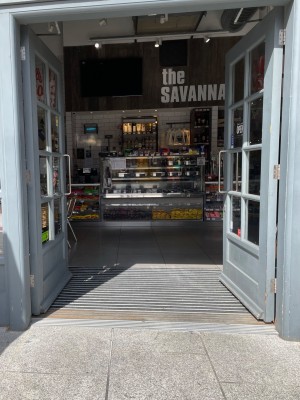 Glass and wood-panelled double doors with handles in centre. Push to open.
