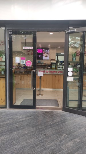 Glass doors with black frames. Silver vertical handles in centre, pull to open.