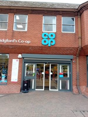 Large automatic grey double door, very wide and wheelchair access will be no problem at all.

Car park over the road with blue badge with small fee