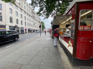 From street, facing at venue. Sidewalk in front. Counter on right.