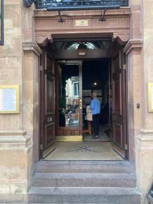 Access through double glass door. Push open from handles in center.